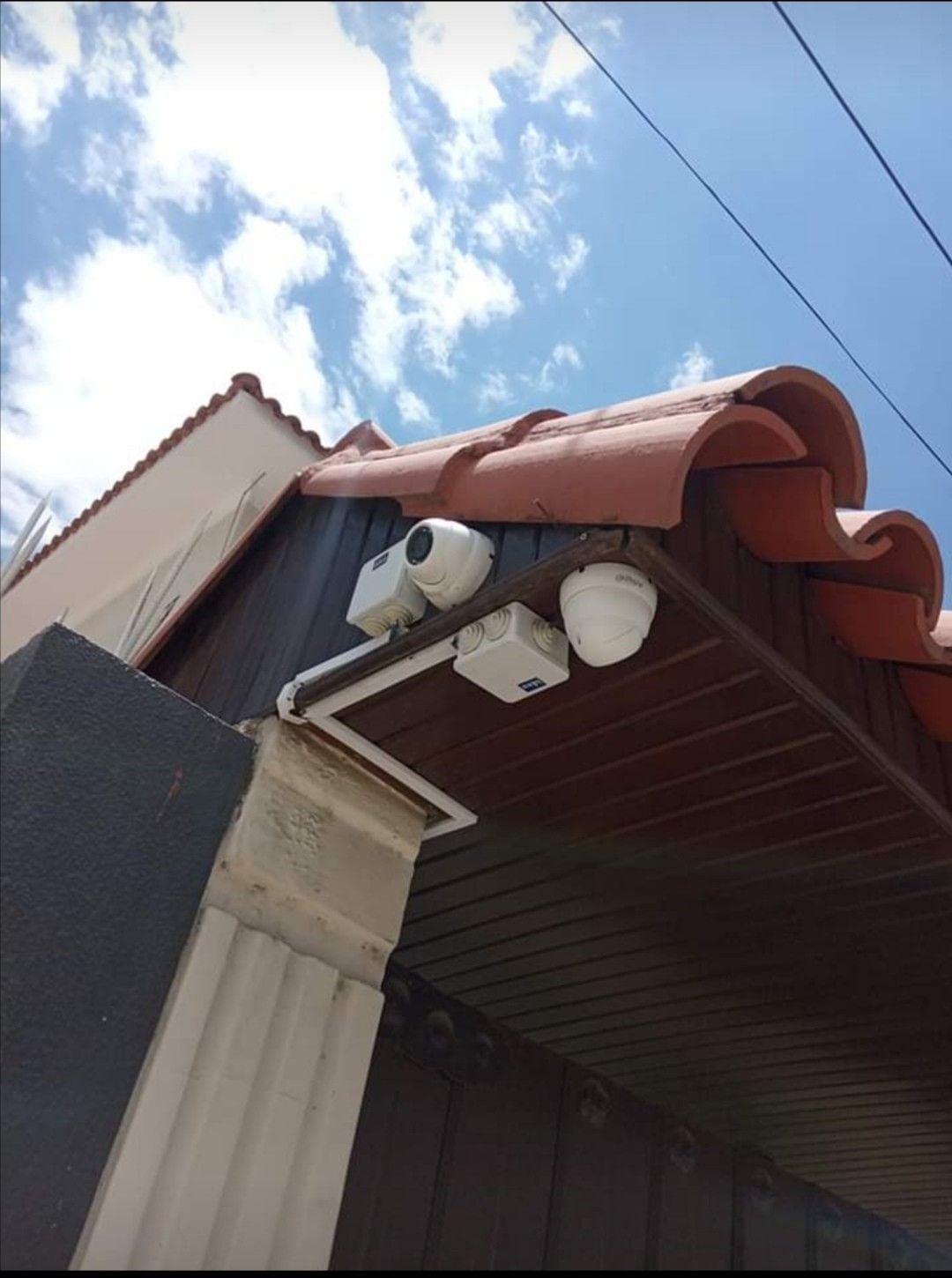 Two of our cameras mounted under the eave of a Cape Town house, cabling run tight to the fascia.